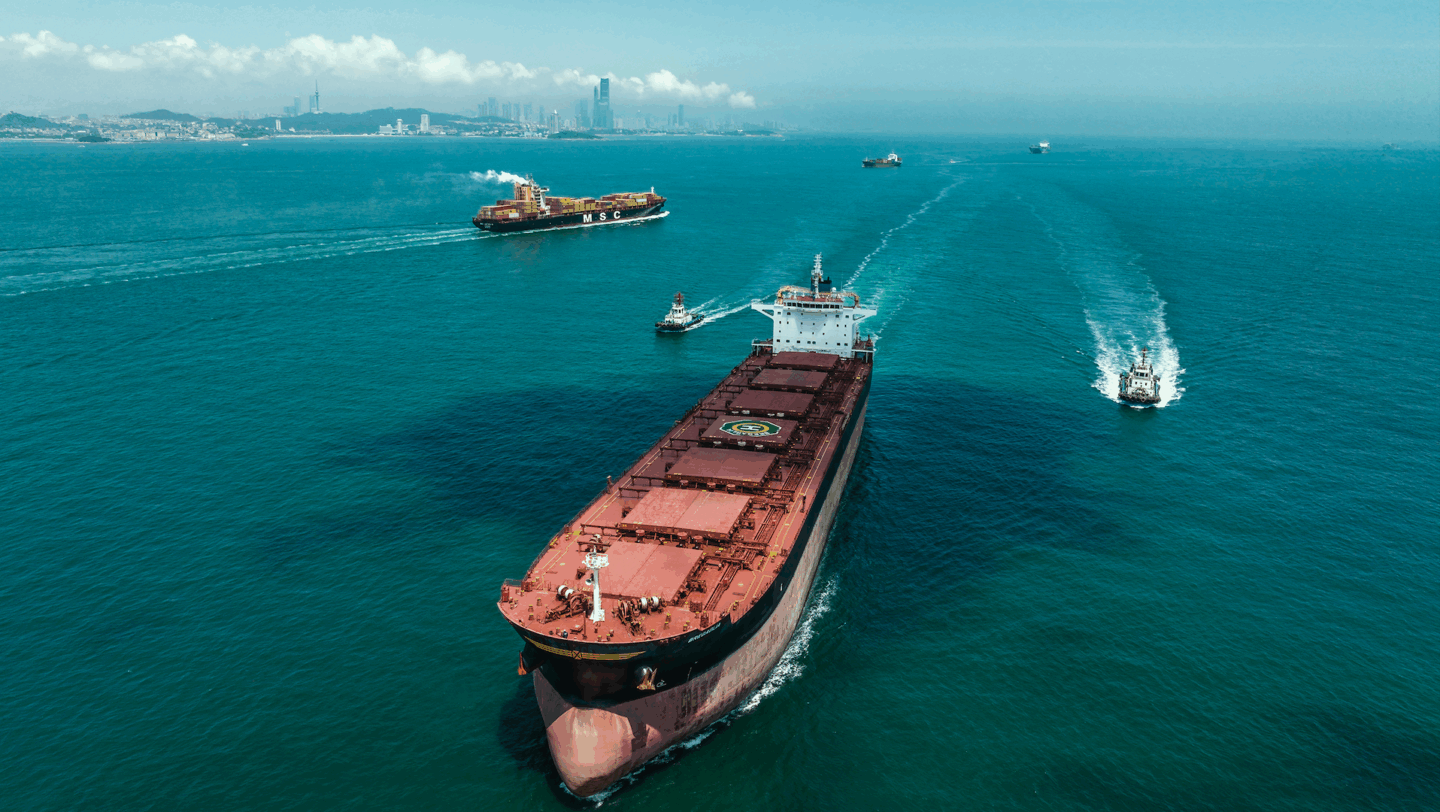 Tugs with tanker in bright green ocean